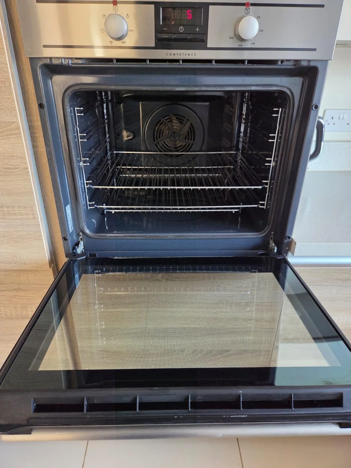 After: the oven clean, with clear door glass and shiny racks